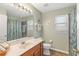 A well-maintained bathroom with a large mirror, tile flooring, and a shower-tub combo at 929 Magnolia Blossom Ct, Apopka, FL 32712