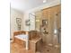 A full bathroom boasts a tiled shower and a garden tub perfect for unwinding after a long day at 929 Magnolia Blossom Ct, Apopka, FL 32712
