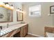 Bathroom featuring double sink vanity with wood cabinets, mirror, and decorative lighting at 929 Magnolia Blossom Ct, Apopka, FL 32712