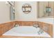 A relaxing bathtub with a decorative shelf and a convenient shower stall adjacent to the tub at 929 Magnolia Blossom Ct, Apopka, FL 32712