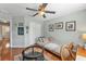 Cozy bedroom with a ceiling fan, comfortable bed, wood floors, and neutral-colored walls at 929 Magnolia Blossom Ct, Apopka, FL 32712