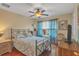 A cozy bedroom featuring a comfortable bed, hardwood floors, and a ceiling fan at 929 Magnolia Blossom Ct, Apopka, FL 32712