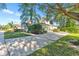 Charming two-story home featuring a well-maintained lawn, mature trees, and a long driveway at 929 Magnolia Blossom Ct, Apopka, FL 32712