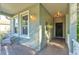 Inviting front porch with brick flooring, neutral wall colors, and stylish decor elements at 929 Magnolia Blossom Ct, Apopka, FL 32712