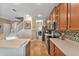 Well-lit kitchen showcases ample counter space, wood cabinetry, and modern appliances at 929 Magnolia Blossom Ct, Apopka, FL 32712
