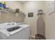 A functional laundry room with a modern washer and dryer, and plenty of storage space at 929 Magnolia Blossom Ct, Apopka, FL 32712