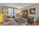 Cozy living room boasts a comfortable sofa, glass table, and elegant wooden display case at 929 Magnolia Blossom Ct, Apopka, FL 32712