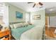 Serene main bedroom featuring soft green walls, a cozy bed, and tranquil decor at 929 Magnolia Blossom Ct, Apopka, FL 32712