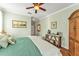 Spacious main bedroom features a comfortable bed, ceiling fan, and ample natural light at 929 Magnolia Blossom Ct, Apopka, FL 32712
