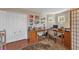 A well-lit home office with a large desk, hardwood floors, and lots of storage space at 929 Magnolia Blossom Ct, Apopka, FL 32712