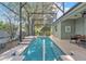 Stunning screened-in pool offering a refreshing escape with mature landscaping and multiple seating areas at 929 Magnolia Blossom Ct, Apopka, FL 32712