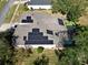 Aerial view of house featuring solar panels and screened enclosure at 1148 Calloway Cir, Clermont, FL 34711