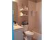 Clean bathroom with a bathtub, toilet, and floating shelves at 1148 Calloway Cir, Clermont, FL 34711