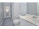 Bathroom with white vanity, toilet, and door to backyard at 1148 Calloway Cir, Clermont, FL 34711