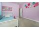 bedroom with single bed, pink walls, and decorative flowers at 1148 Calloway Cir, Clermont, FL 34711