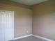 Empty bedroom with neutral walls and double door closet at 1148 Calloway Cir, Clermont, FL 34711