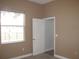 Bedroom with window, closet, and neutral-toned walls at 1148 Calloway Cir, Clermont, FL 34711