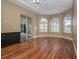 Bright bedroom with hardwood floors, arched windows and patio access at 1148 Calloway Cir, Clermont, FL 34711