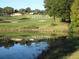 Picturesque golf course with water feature and 'Legends' sign at 1148 Calloway Cir, Clermont, FL 34711