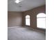 Main bedroom with two arched windows and ceiling fan at 1148 Calloway Cir, Clermont, FL 34711