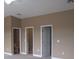 Main bedroom with multiple doors and neutral-toned walls at 1148 Calloway Cir, Clermont, FL 34711