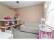 Playroom with sofa, various toys, and white table at 1148 Calloway Cir, Clermont, FL 34711