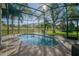 Inviting pool area with screened enclosure, providing ample space for relaxation and entertainment at 1148 Calloway Cir, Clermont, FL 34711