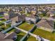 An aerial view of homes in a Florida neighborhood, showcasing a spacious backyard at 1961 Nations Way, Saint Cloud, FL 34769