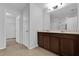 Modern bathroom featuring double vanity with tile floors and a large mirror at 1961 Nations Way, Saint Cloud, FL 34769