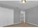 Neutral carpeted bedroom with gray walls and white trim and a door leading to an adjoined room at 1961 Nations Way, Saint Cloud, FL 34769