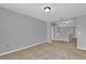 Neutral carpeted bedroom with gray walls and white trim, featuring open hallway at 1961 Nations Way, Saint Cloud, FL 34769