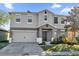 Charming two-story home featuring a two-car garage and manicured front yard at 1961 Nations Way, Saint Cloud, FL 34769