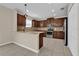 Bright kitchen with stainless steel appliances, brown cabinetry, and light countertops at 1961 Nations Way, Saint Cloud, FL 34769