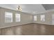 Living room featuring laminate flooring, bright lighting, and ample space at 1961 Nations Way, Saint Cloud, FL 34769