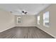 Bright living room featuring hardwood floors, a ceiling fan, and ample natural light at 1961 Nations Way, Saint Cloud, FL 34769