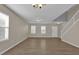 Living room with laminate flooring, neutral walls, staircase and ample natural light at 1961 Nations Way, Saint Cloud, FL 34769