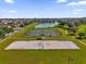 Community park featuring sports facilities, a sand volleyball court, and a picturesque lake with a fountain at 1961 Nations Way, Saint Cloud, FL 34769