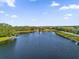 Scenic view of the community pond with a fountain, surrounded by lush greenery and well-maintained landscaping at 1961 Nations Way, Saint Cloud, FL 34769