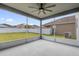 Covered lanai features a ceiling fan, concrete floor and view of the backyard at 1961 Nations Way, Saint Cloud, FL 34769