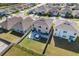 Aerial view showcasing a home with a backyard patio and hot tub in a residential neighborhood at 2011 Chickasaw Blvd, Davenport, FL 33837