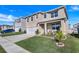 Two-story house with beige exterior, two-car garage, and a nicely landscaped yard at 2011 Chickasaw Blvd, Davenport, FL 33837