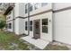 Backyard exterior of home with sliding glass doors leading to a concrete patio at 22103 Sandalwood Dr # 103, Wildwood, FL 34785