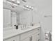 Bright bathroom with a modern vanity, ample lighting, and clean, white finishes at 22103 Sandalwood Dr # 103, Wildwood, FL 34785