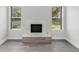 Bright living room showcasing a fireplace, wood floors, and natural light from dual windows at 22103 Sandalwood Dr # 103, Wildwood, FL 34785