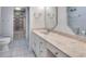 Bathroom featuring vanity with marble countertop, tile flooring, mirror, and walk-in closet at 33516 Overton Dr, Leesburg, FL 34788