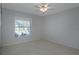 Neutral bedroom features carpet, a window with blinds and a ceiling fan at 33516 Overton Dr, Leesburg, FL 34788