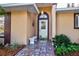 Inviting front entrance with a tiled walkway, decorative details, and tasteful landscaping at 33516 Overton Dr, Leesburg, FL 34788
