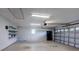 Spacious two car garage with white brick walls and shelving at 33516 Overton Dr, Leesburg, FL 34788