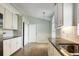 Bright kitchen features granite countertops, stainless steel sink, white cabinets, and wood flooring at 33516 Overton Dr, Leesburg, FL 34788
