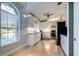 Bright kitchen with stainless appliances, white cabinets and countertops, tile backsplash and light wood floors at 33516 Overton Dr, Leesburg, FL 34788